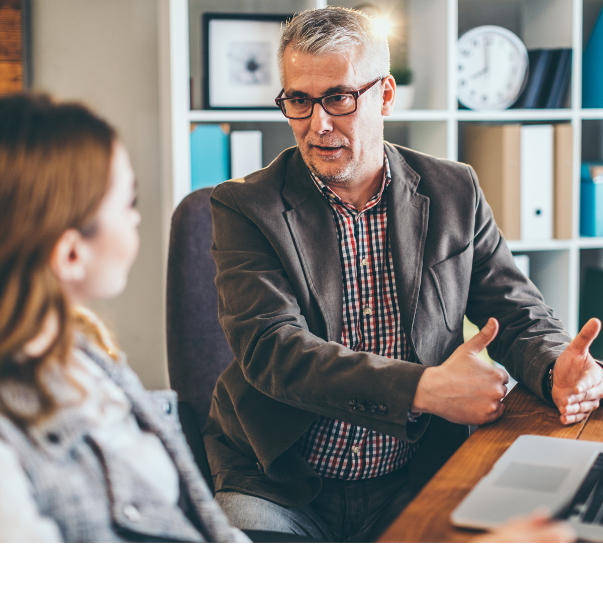 Professional man consulting with woman in office setting