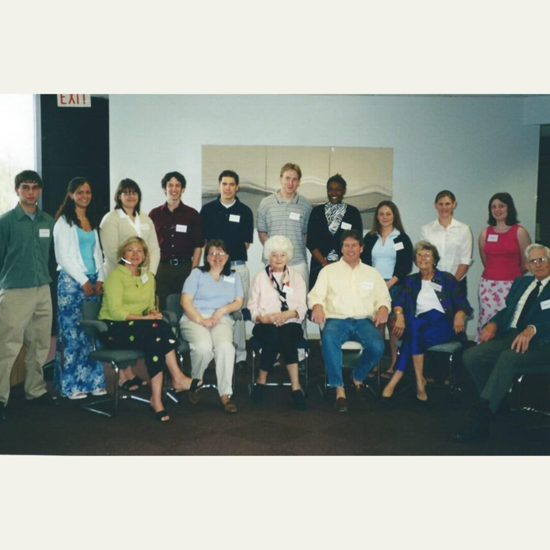 Large group of people posing indoors at formal event