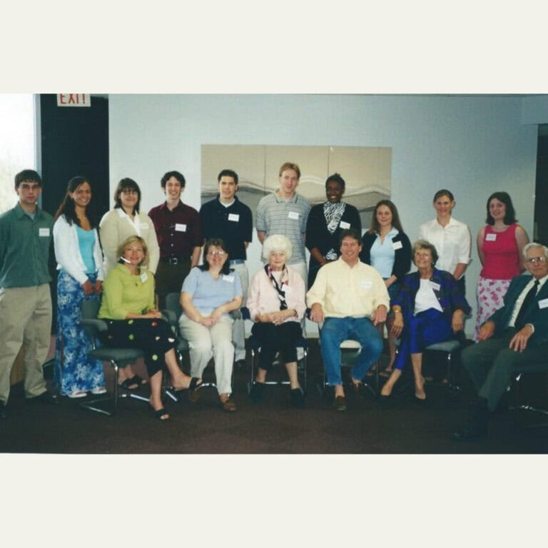 Large group of people posing indoors at formal event