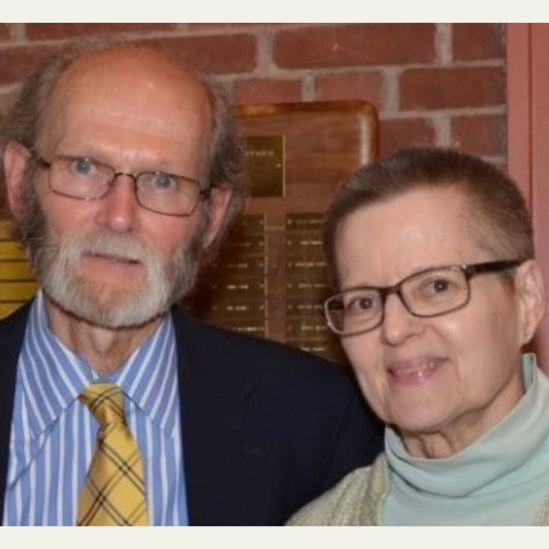 Older man and woman smiling together indoors