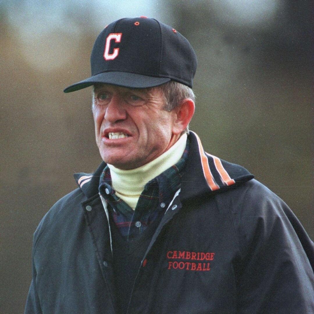 Man wearing Cambridge Football cap and jacket