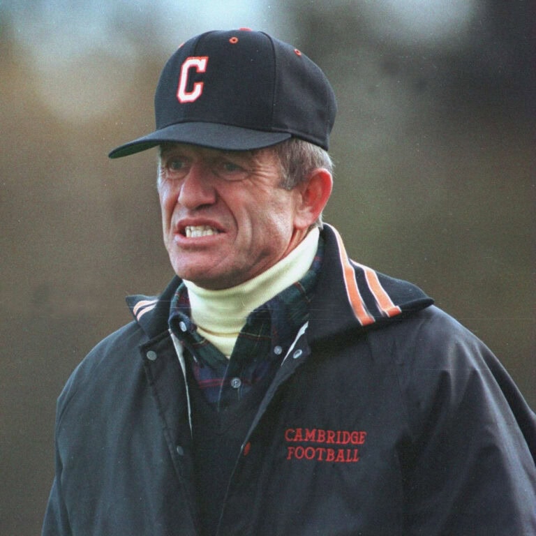 Man wearing Cambridge Football cap and jacket