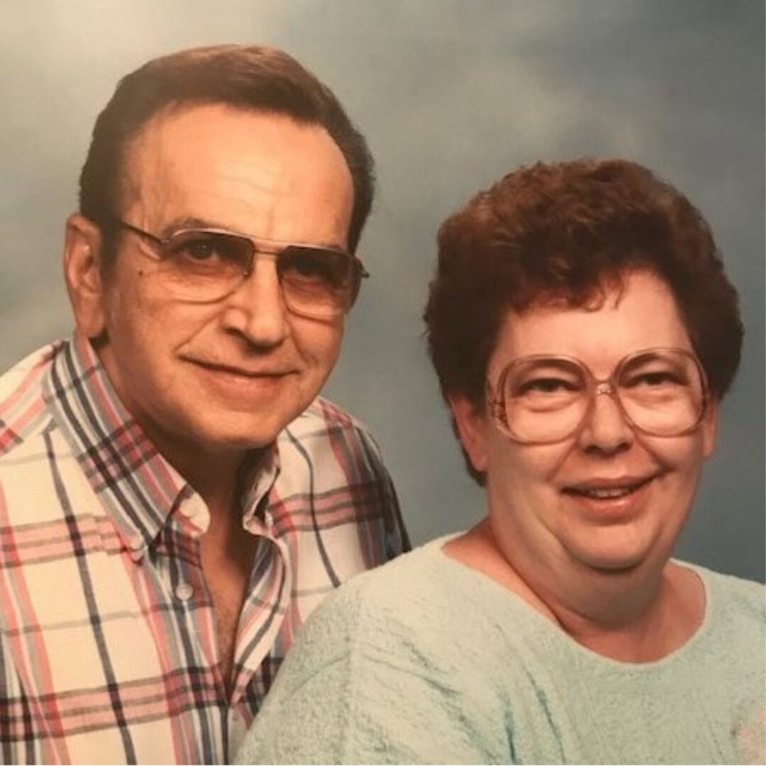 Smiling older couple posing together in vintage portrait photo