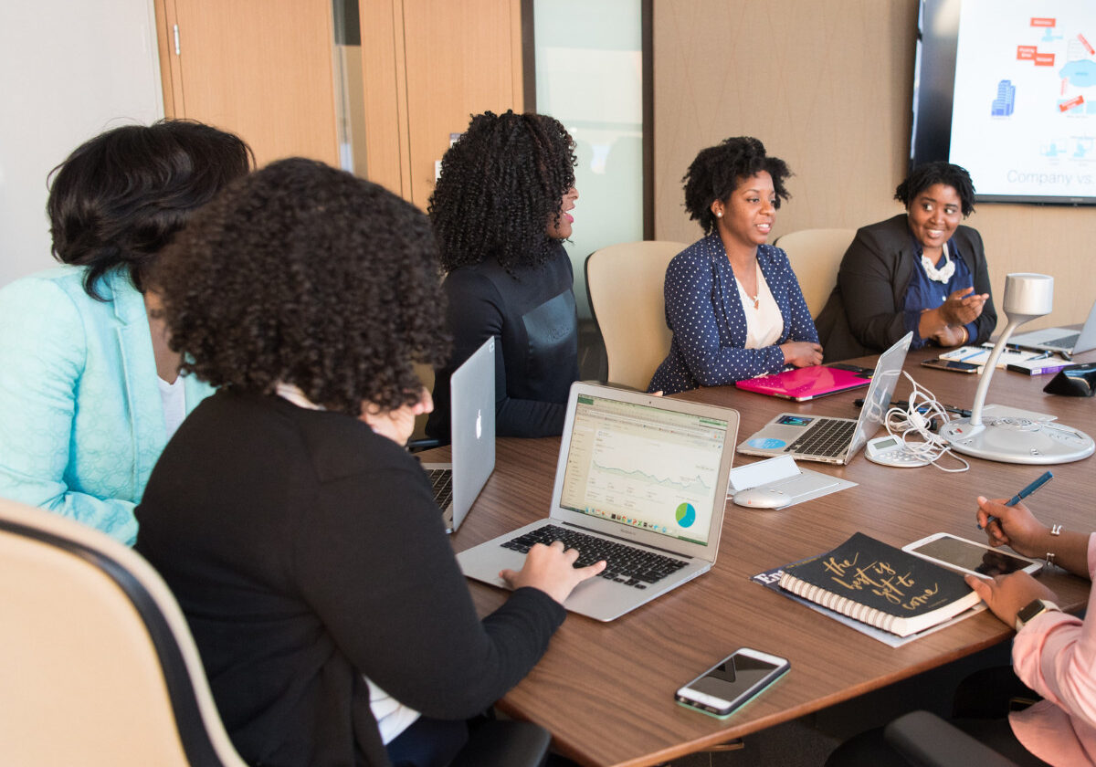 Diverse women collaborating in a modern office conference room