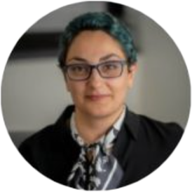 Person with glasses and short hair, professional attire.